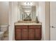 Bathroom showcasing a vanity with granite countertops, a mirror, and modern lighting fixtures at 13128 Foxtail Fern Dr, Riverview, FL 33579