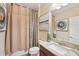 This bathroom features a mirror, granite counters, modern art, and a shower with a beautiful shower curtain at 13128 Foxtail Fern Dr, Riverview, FL 33579