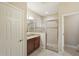 Bathroom featuring a granite vanity, a framed mirror, and a glass-enclosed shower at 13128 Foxtail Fern Dr, Riverview, FL 33579