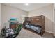 This bedroom has carpet floors, a TV, a desk, and a bunk bed perfect for  at 13128 Foxtail Fern Dr, Riverview, FL 33579