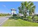 Triple Creek community entrance featuring a nautical-themed gatehouse and lush landscaping with palm trees at 13128 Foxtail Fern Dr, Riverview, FL 33579
