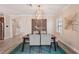 Chic dining room with modern lighting and decor adjacent to the kitchen at 13128 Foxtail Fern Dr, Riverview, FL 33579