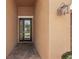 Close-up of a decorative front door with glass inserts, sidelight and patterned brick walkway leading to the entrance at 13128 Foxtail Fern Dr, Riverview, FL 33579