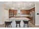 Modern kitchen with a large island, stainless steel appliances, and stylish pendant lighting at 13128 Foxtail Fern Dr, Riverview, FL 33579
