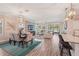 Open-concept living space with modern lighting, stylish furnishings, and access to the outdoor area at 13128 Foxtail Fern Dr, Riverview, FL 33579