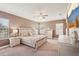 Comfortable main bedroom with neutral tones, a ceiling fan, and large windows for natural light at 13128 Foxtail Fern Dr, Riverview, FL 33579