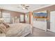 Spacious main bedroom featuring a large dresser, a ceiling fan, and a TV on the wall at 13128 Foxtail Fern Dr, Riverview, FL 33579