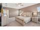 Inviting main bedroom with an elegant bed frame, side tables, and soft, neutral decor at 13128 Foxtail Fern Dr, Riverview, FL 33579