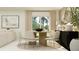 Bright dining area features a wood table, decorative rug, stylish seating, and sliding glass doors for natural light at 14959 Topaz Blue St, Wimauma, FL 33598