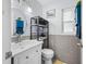 Well-lit bathroom featuring a modern vanity, round mirror, and blue accents at 1641 Jeffords St, Clearwater, FL 33756