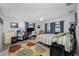 Spacious bedroom with a ceiling fan, workspace, and plenty of natural light from the windows at 1641 Jeffords St, Clearwater, FL 33756