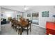 Open-concept dining area with a large table and seating for eight, next to the living room at 1641 Jeffords St, Clearwater, FL 33756
