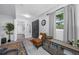 Foyer with tile flooring, decorative chair, and view into the kitchen at 1641 Jeffords St, Clearwater, FL 33756
