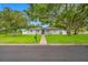 Inviting single-story home with well-maintained lawn, mature trees, and a brick walkway at 1641 Jeffords St, Clearwater, FL 33756