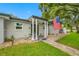 Front exterior of single-story home with walkway, lush lawn, well-maintained landscape, and an American flag at 1641 Jeffords St, Clearwater, FL 33756