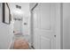 Hallway featuring sliding barn door, neutral paint, and tiled flooring leading to other rooms in the home at 1641 Jeffords St, Clearwater, FL 33756