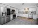 Modern kitchen featuring stainless steel appliances, granite counters, and bright white cabinets at 1641 Jeffords St, Clearwater, FL 33756