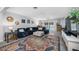 Spacious living room with a large sectional sofa, patterned rug, and pool view at 1641 Jeffords St, Clearwater, FL 33756