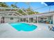 Large screened in pool area with seating, outdoor grill, and a view of the backyard at 1641 Jeffords St, Clearwater, FL 33756
