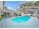 Screened-in pool with lounge chairs, dining set, grill, and landscaped surroundings at 1641 Jeffords St, Clearwater, FL 33756