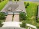 Aerial view of townhome with brick driveway, two-car garage, and well-maintained landscaping at 16898 Balance Cv, Land O Lakes, FL 34638