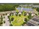 Aerial view of neighborhood homes overlooking a beautiful lake surrounded by lush greenery at 16898 Balance Cv, Land O Lakes, FL 34638