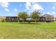 Well maintained backyard featuring manicured lawn, beautiful landscape, and cozy enclosed lanai at 16898 Balance Cv, Land O Lakes, FL 34638