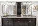 Bathroom featuring a granite countertop with dual sinks and dark wood cabinetry at 16898 Balance Cv, Land O Lakes, FL 34638