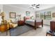 Tranquil bedroom with a wooden bed frame, soft lighting, and a view to the outdoors at 16898 Balance Cv, Land O Lakes, FL 34638