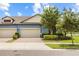 Charming single-Gathering home has well-maintained landscaping, a brick driveway and two-car garage at 16898 Balance Cv, Land O Lakes, FL 34638