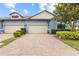 Charming townhome with a brick driveway, two-car garage, and well-manicured landscaping at 16898 Balance Cv, Land O Lakes, FL 34638