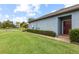 A single-Gathering home's side-yard with lush green grass and manicured shrubbery at 16898 Balance Cv, Land O Lakes, FL 34638