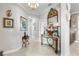 Elegant foyer showcases a decorative table, mirror, chandelier, and beautiful tiled floors at 16898 Balance Cv, Land O Lakes, FL 34638