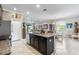 Open concept kitchen with a central island offering ample space and connectivity to the dining and living areas at 16898 Balance Cv, Land O Lakes, FL 34638