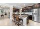Gourmet kitchen featuring a spacious island, stainless steel appliances, and dark wood cabinetry for the discerning chef at 16898 Balance Cv, Land O Lakes, FL 34638