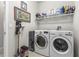 Well-equipped laundry room featuring modern washer and dryer, maximizing convenience for everyday tasks at 16898 Balance Cv, Land O Lakes, FL 34638