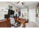 Well-lit home office with a large wooden desk, built-in cabinets, and a view to the living area at 16898 Balance Cv, Land O Lakes, FL 34638