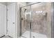 Shower featuring a shower head, seat, soap holder, and tile walls with glass door entry at 16898 Balance Cv, Land O Lakes, FL 34638