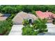 Aerial view of a beautiful home featuring lush landscaping, tile roof and long driveway at 17203 Talence Ct, Tampa, FL 33647