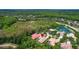 An aerial view showcases a tan-roofed home among landscaped yards near a lake at 17203 Talence Ct, Tampa, FL 33647