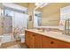 Inviting bathroom featuring a vanity, decorative mirror, and a shower with a patterned curtain and tiled walls at 17203 Talence Ct, Tampa, FL 33647