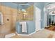 Bright bathroom features a glass-enclosed shower with tile surround and blue walls at 17203 Talence Ct, Tampa, FL 33647