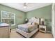 Well-lit bedroom with a queen bed, side tables, and window with white blinds, creating a cozy ambiance at 17203 Talence Ct, Tampa, FL 33647