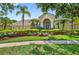 Charming home with well-manicured landscaping, lush green lawn, and paved walkway at 17203 Talence Ct, Tampa, FL 33647