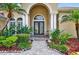 Elegant front door with sidelights, columns, and manicured landscaping at 17203 Talence Ct, Tampa, FL 33647