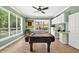 Entertaining game room featuring a pool table, custom built-ins, and an inviting view of the pool area at 17203 Talence Ct, Tampa, FL 33647