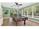 Bright game room featuring a pool table, large windows, and views of the outdoors, perfect for entertainment at 17203 Talence Ct, Tampa, FL 33647