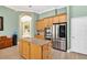 Open kitchen featuring granite countertops, stainless steel appliances, and a convenient island, perfect for culinary enthusiasts at 17203 Talence Ct, Tampa, FL 33647