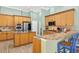 Spacious kitchen with wooden cabinets, stainless steel appliances, and granite countertops, ideal for cooking and entertaining at 17203 Talence Ct, Tampa, FL 33647