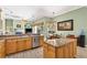Kitchen with granite countertops and stainless appliances seamlessly connecting to dining and living spaces for easy entertaining at 17203 Talence Ct, Tampa, FL 33647